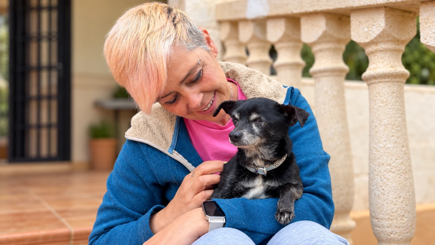 Amparo stroking a small dog